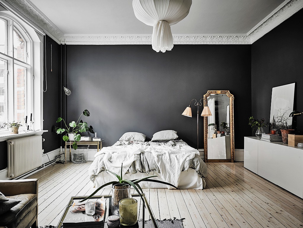 Charcoal grey walls highlight the white crown molding in a turn-of-the-century home