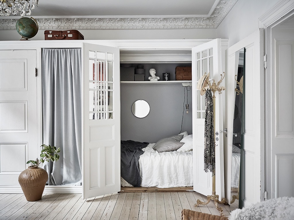 A custom-built bed nook solution integrated inside a cabinet