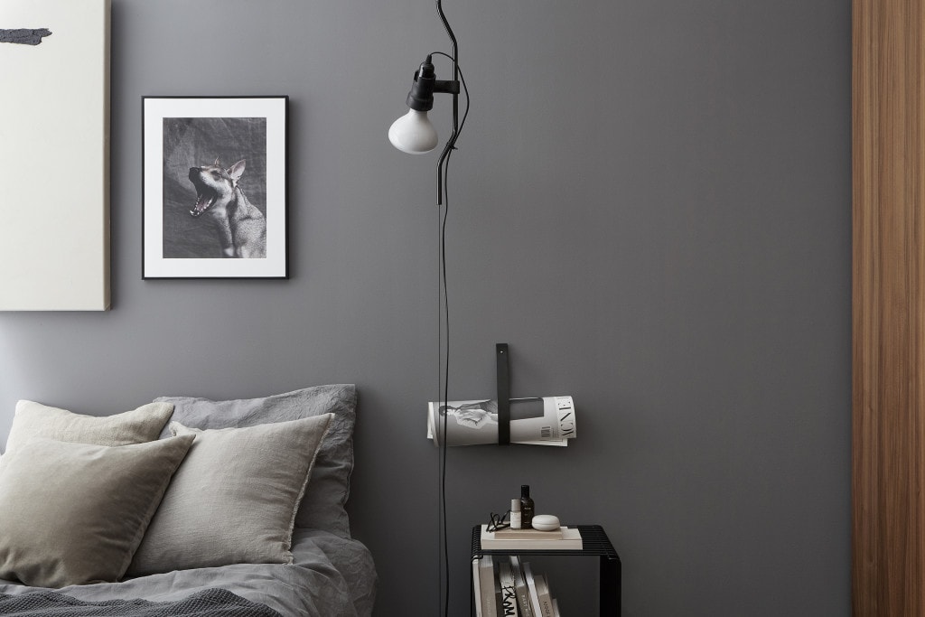 Soft grey walls pair up nicely with the warm wood tones in this bedroom