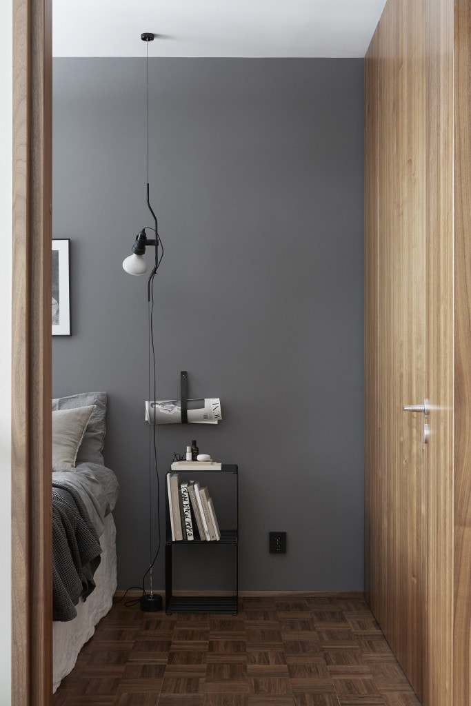 Soft grey walls pair up nicely with the warm wood tones in this bedroom