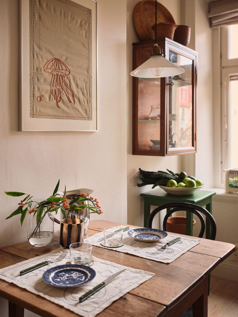 A kitchen dining area with a vintage table and black bentwood chairs