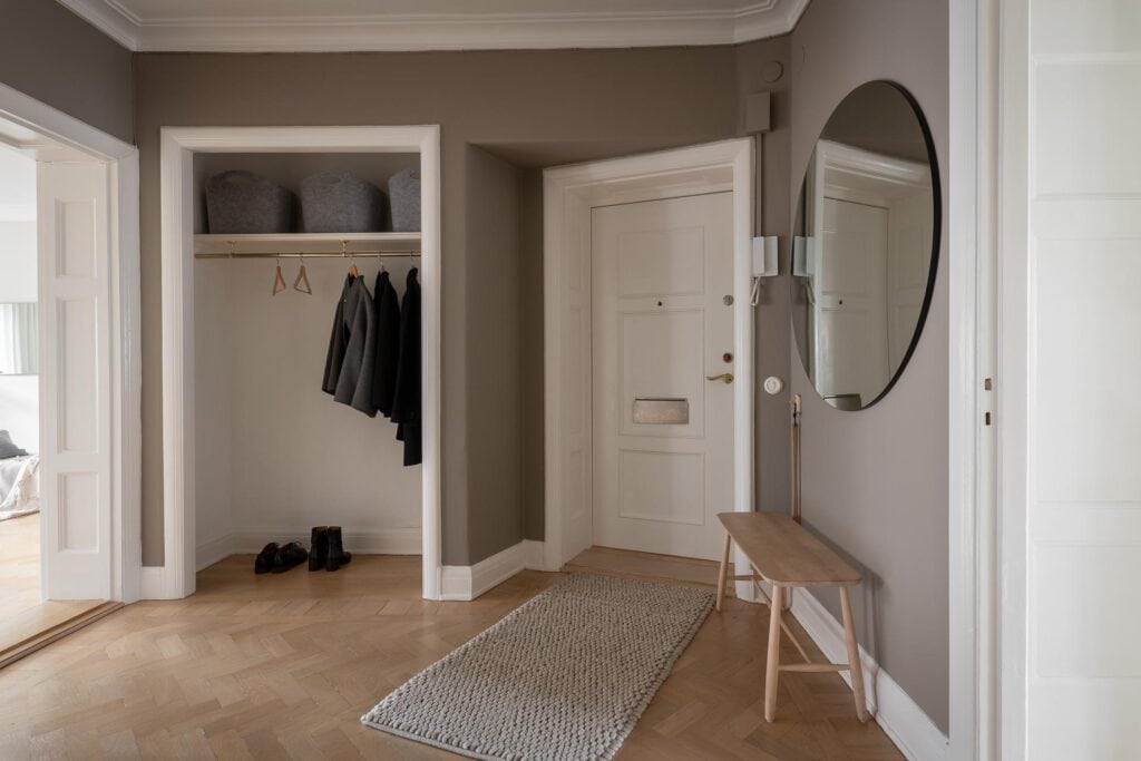 A dark grey hallway with a niche space for storing jackets and shoes