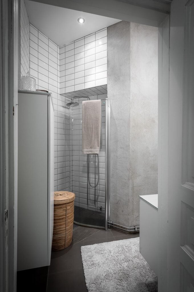 A bathroom with a concrete finish on the walls