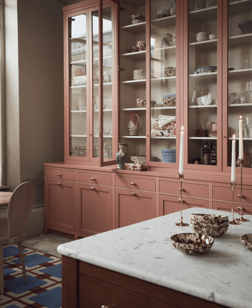 A pink kitchen with shaker-style cabinets