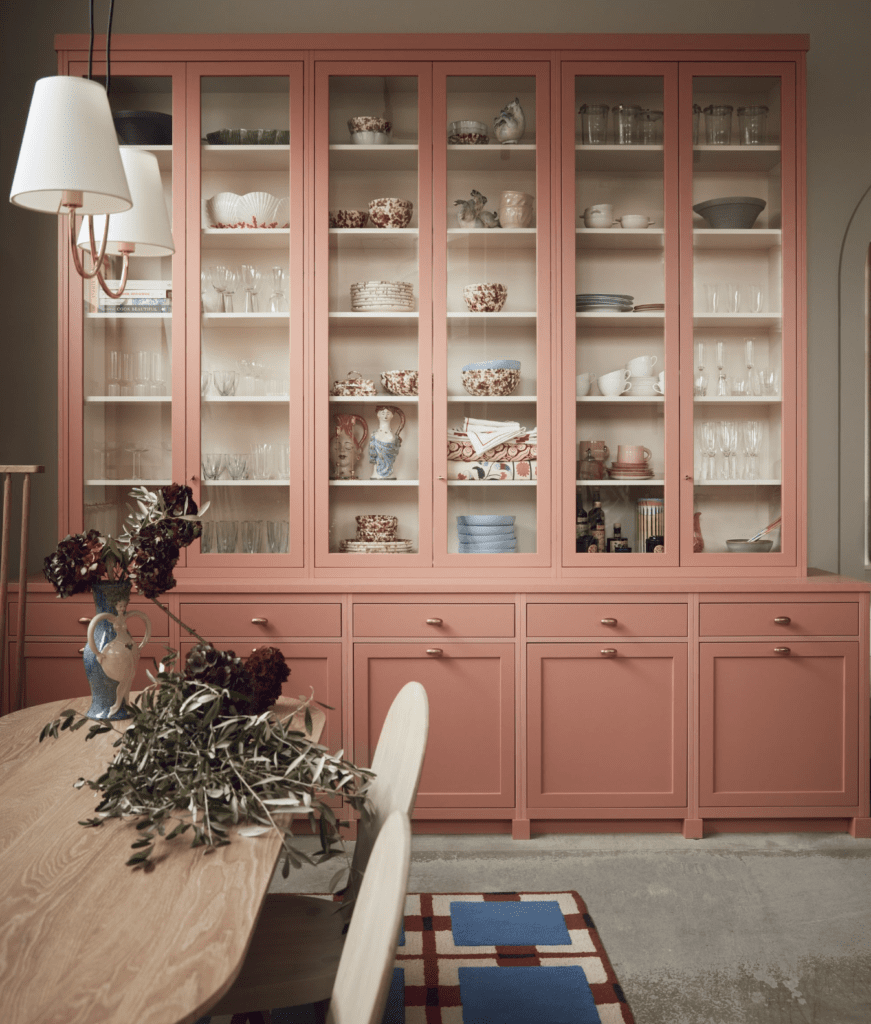 A pink kitchen with shaker-style cabinets