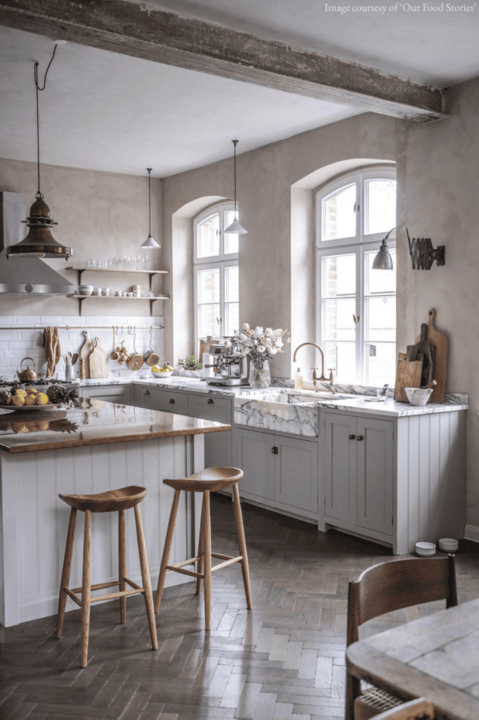 A beautiful marble farmhouse sink in an elegant grey farmhouse kitchen