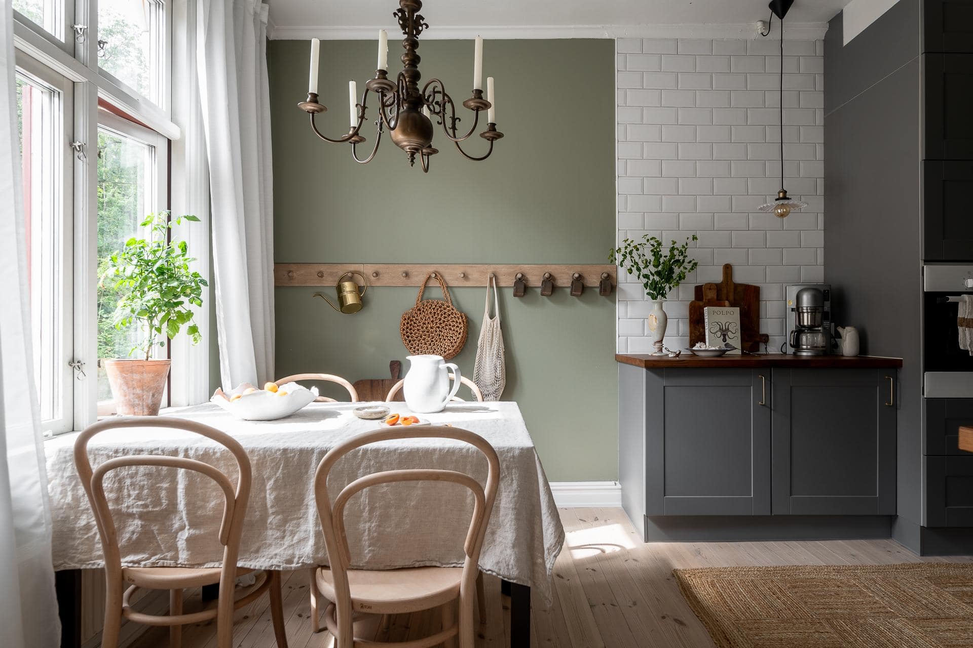 Grey kitchen cabinets against sage green walls in an attic