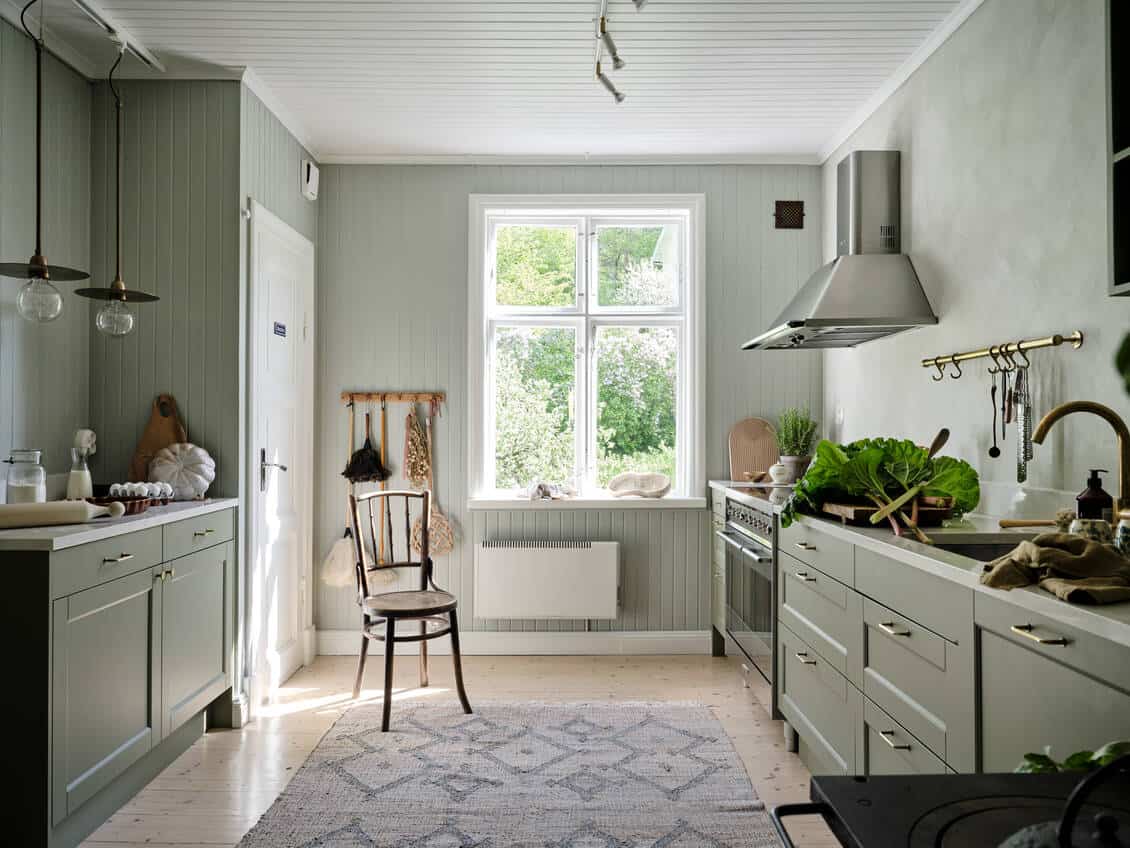 Sage green kitchen with shiplap walls in a Toronto home, Ontario