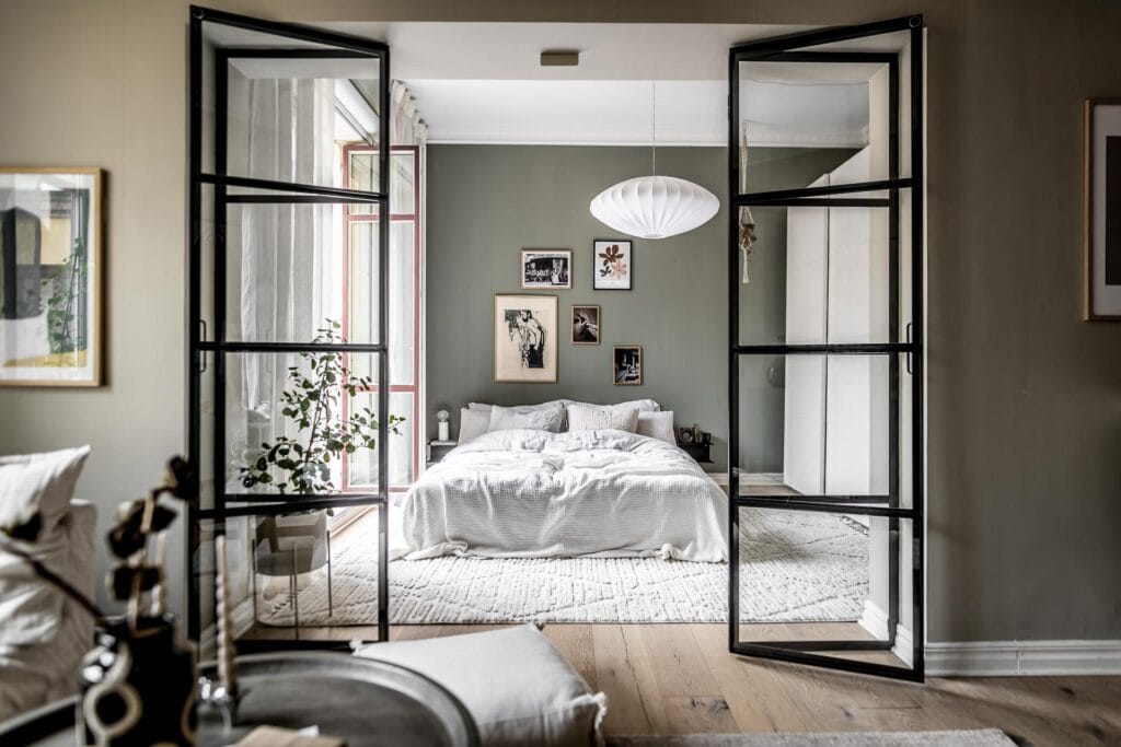 A glass partition to close off the bedroom from the rest of the studio apartment