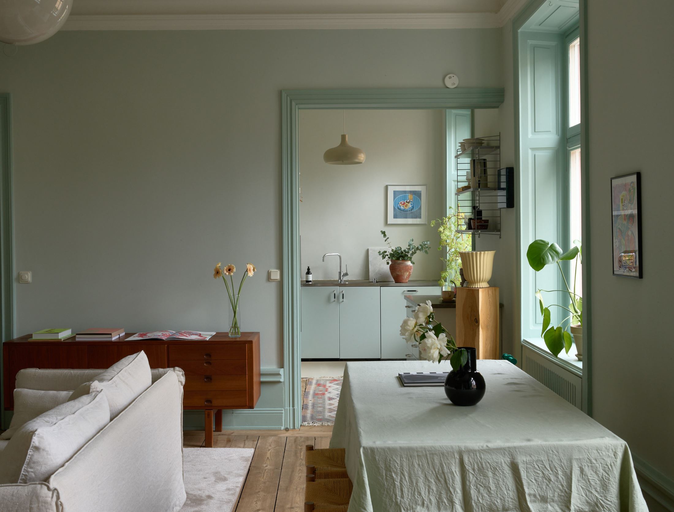 Sage green kitchen cabinets in a green color palette apartment - COCO  LAPINE DESIGNCOCO LAPINE DESIGN