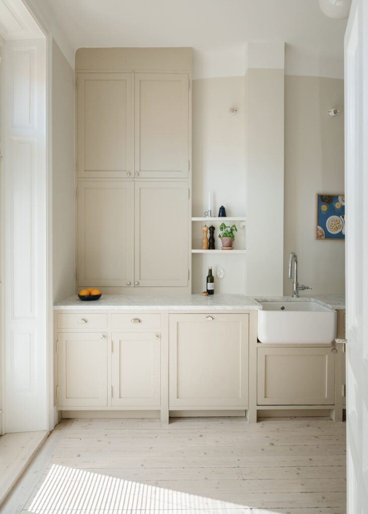 Antique white shaker cabinets and a farmhouse sink for a traditional look