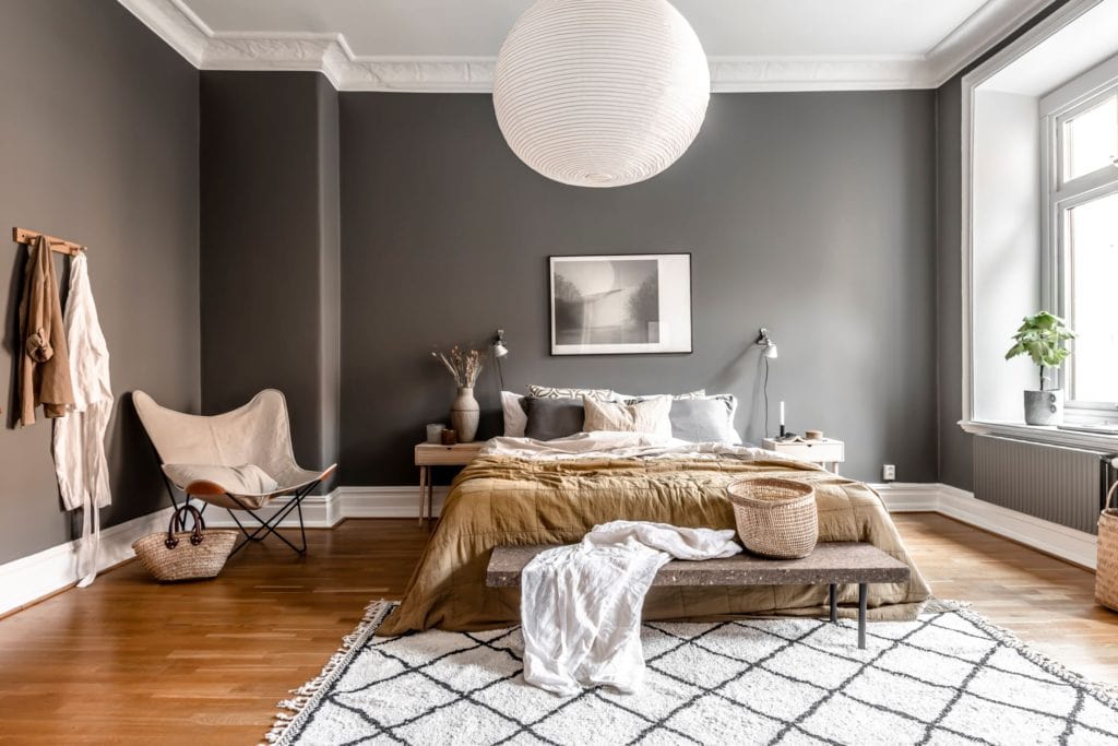 Dark greys paired up with warm colors in the textiles and accessories