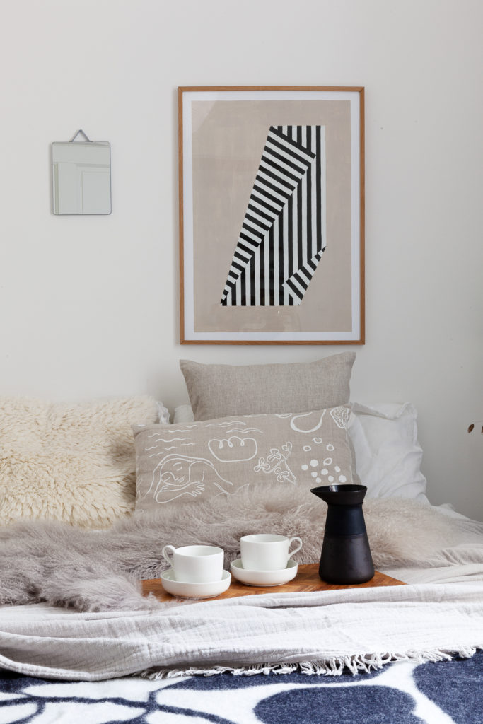 Black and white Linnea Andersson blanket in a white bedroom