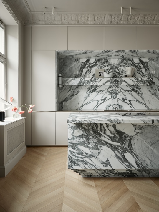 A sculptural marble kitchen island with impressive veining