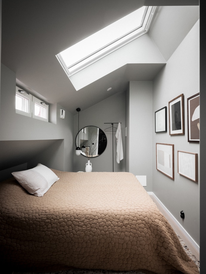 An attic bedroom with a niche space for the bed