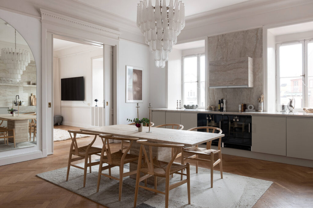Oak Wishbone Chairs in a beautiful kitchen dining room setting with beige marble details