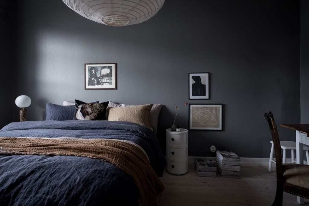 A cool grey bedroom with blue tones in the bedding