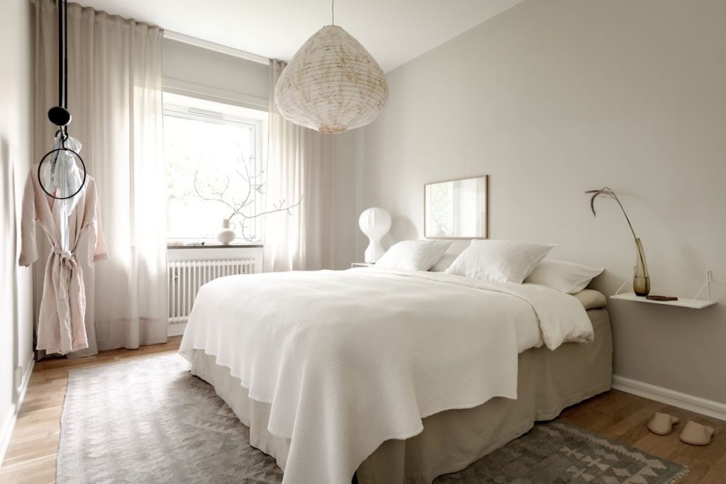 A subtle grey-beige bedroom wall color and cirsp white bedding