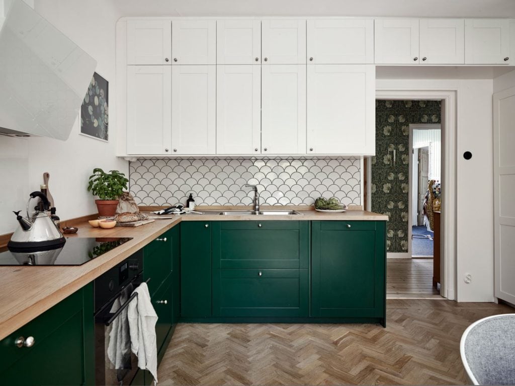 A forest green kitchen with wood countertops