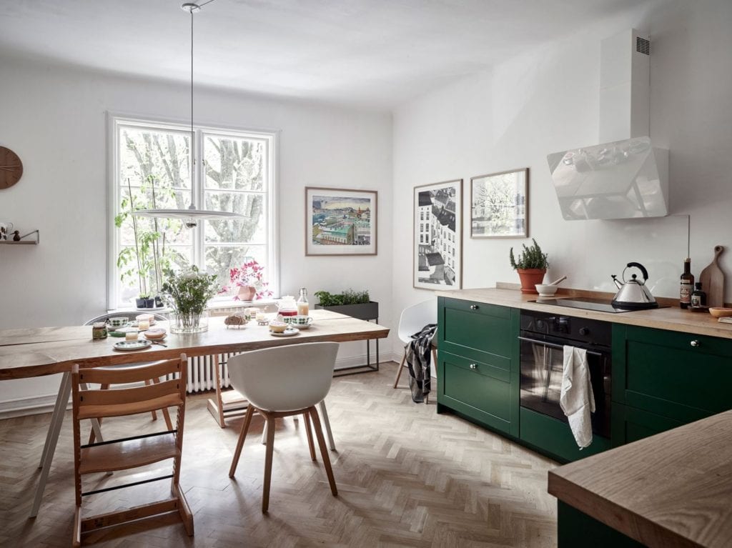 A forest green kitchen with wood countertops