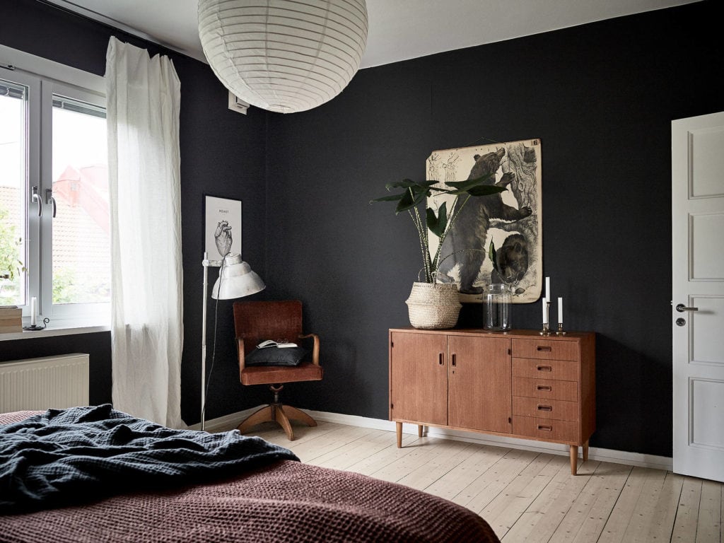 A very dark grey bedroom results in a unique, moody look