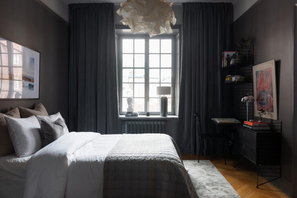 Dark grey bedroom walls combined with contrasting white elements