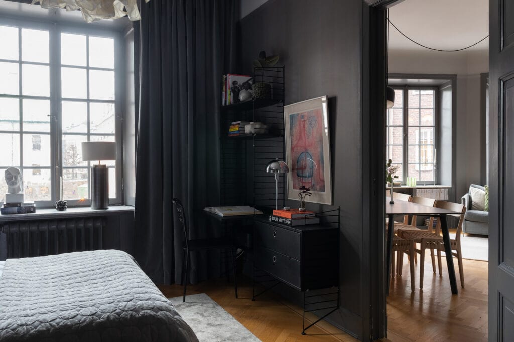 Dark grey bedroom walls combined with contrasting white elements