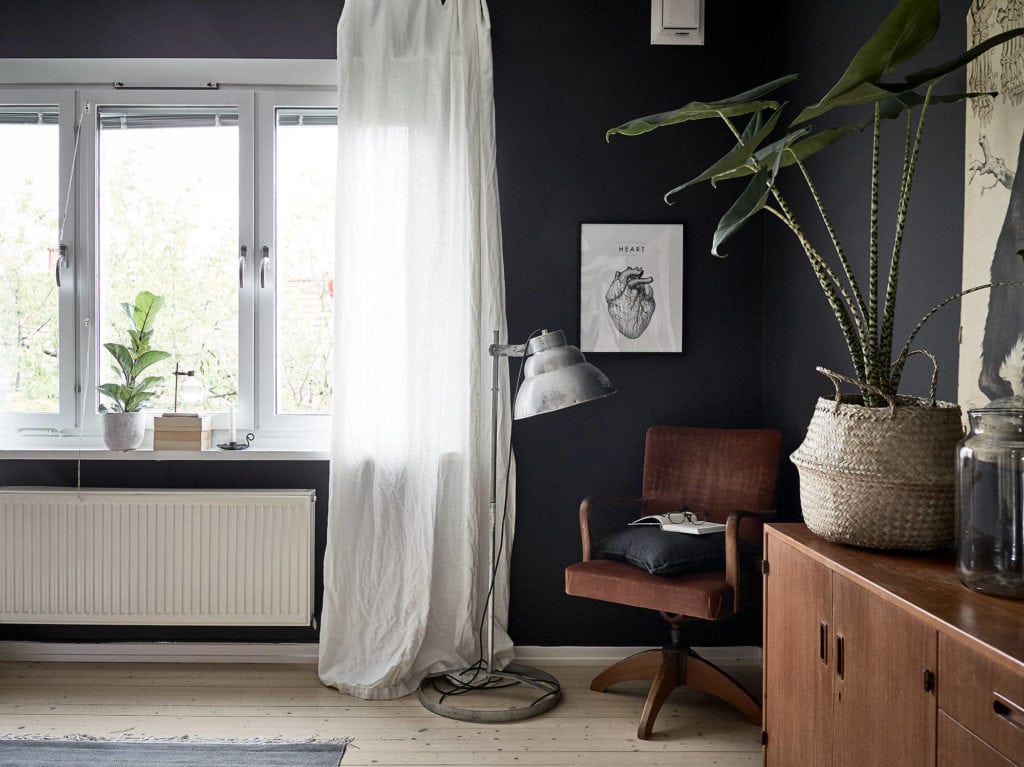 A very dark grey bedroom results in a unique, moody look